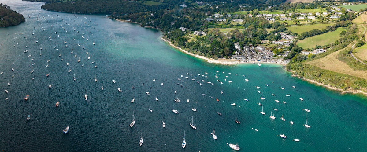 Aerial panorama of Helford Passage and river in Cornwall, UK with marina and sailing boats