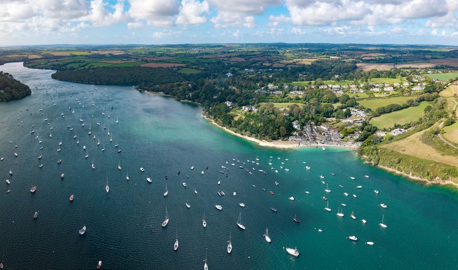 Aerial panorama of Helford Passage and river in Cornwall, UK with marina and sailing boats