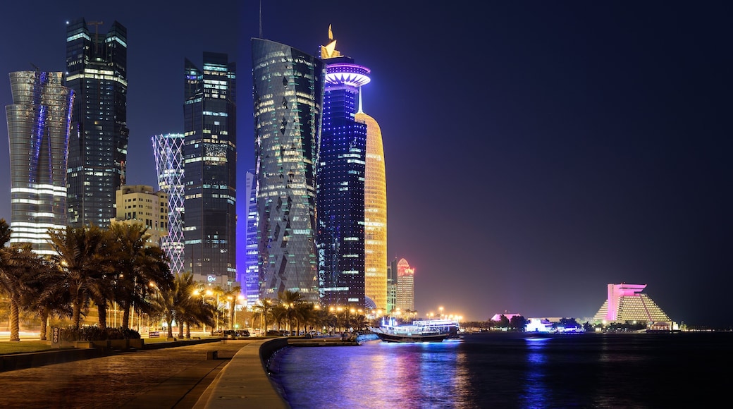 Doha Corniche which includes night scenes, a bay or harbor and a skyscraper