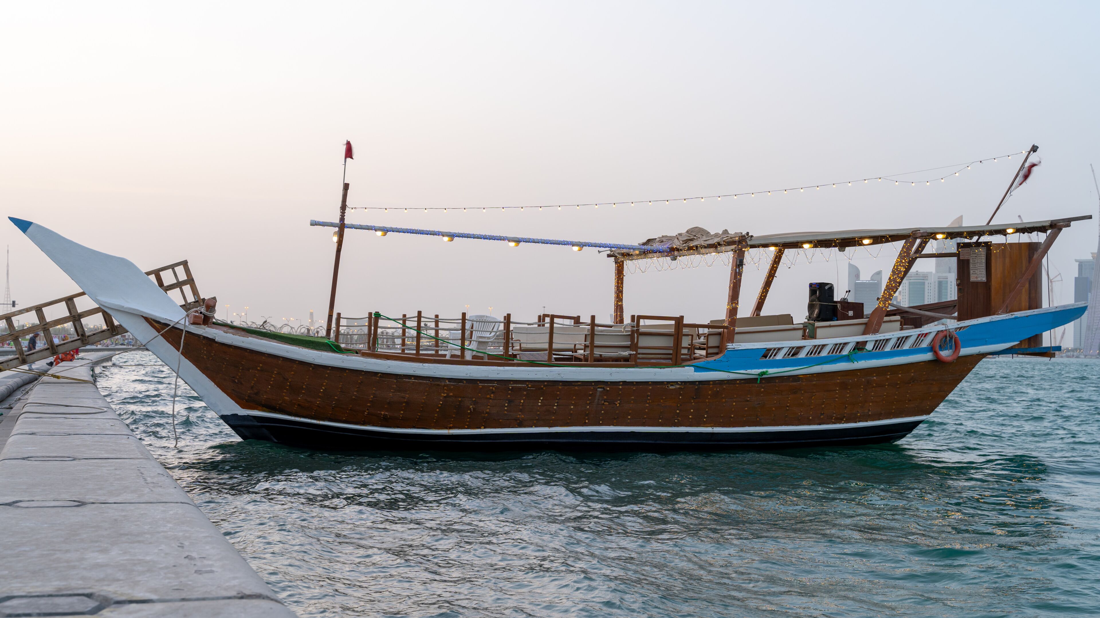 Qatar's Traditional fishing boat Dhow waiting for a boat ride in Qatar corniche. boat ride is one of the special tourist activity.