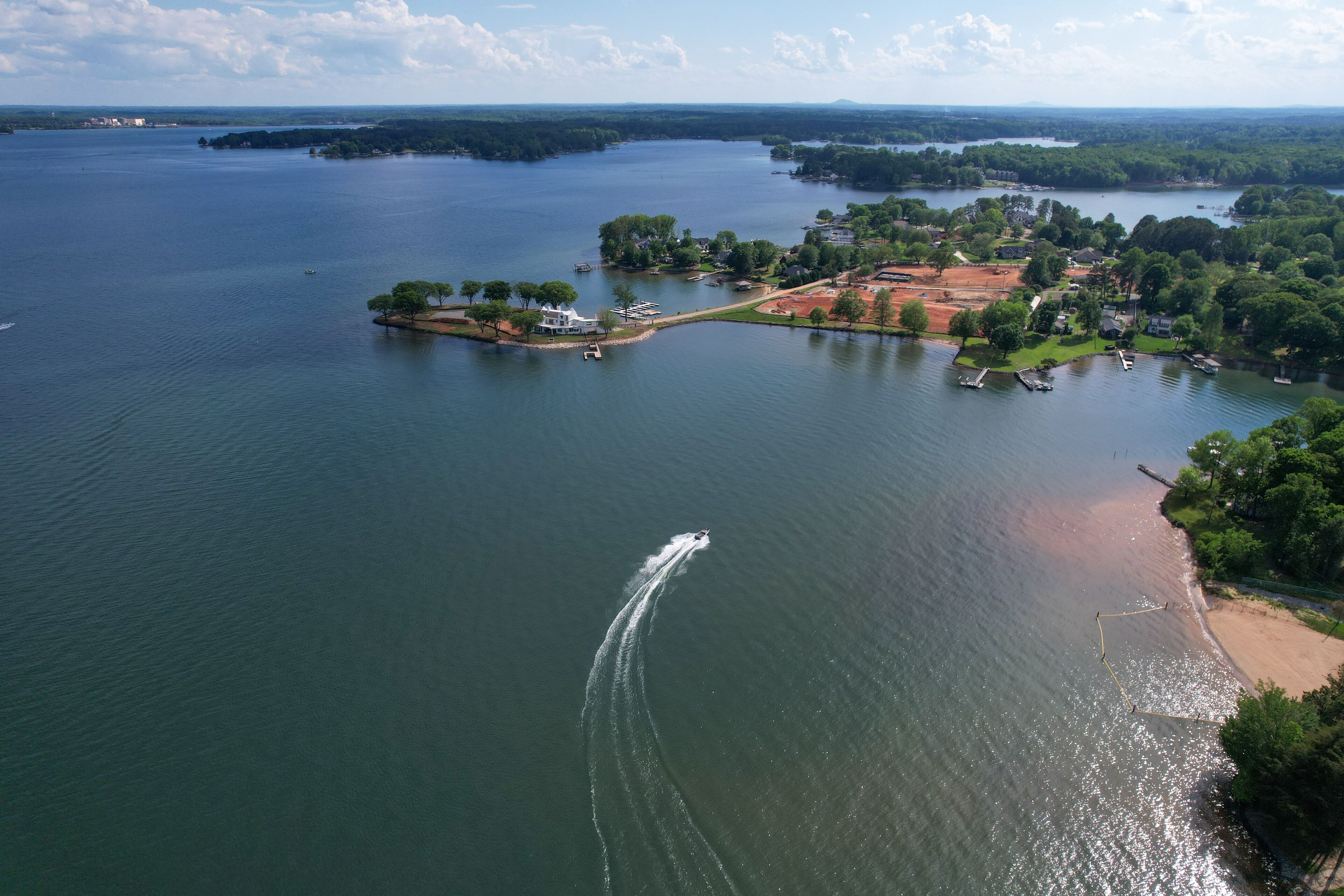 Pleasure boat heads to wealthy shore on Lake Norman in North Carolina