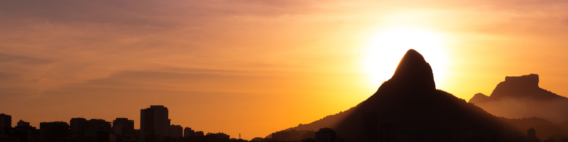 View of Rio de Janeiro Sunset Behind Mountains at the Lake