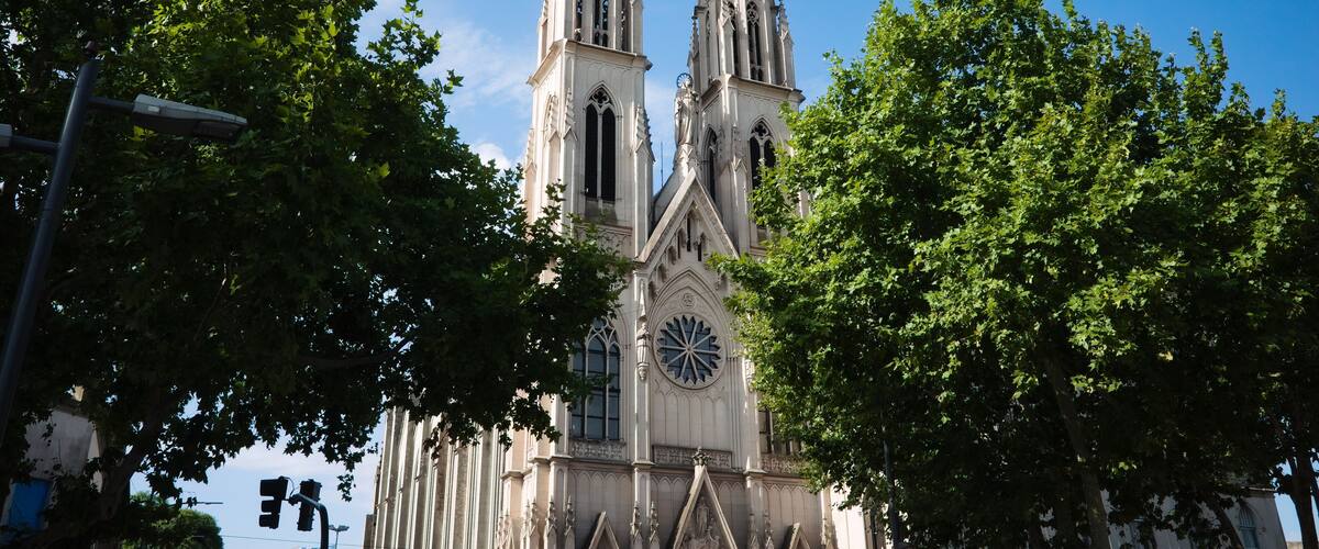A cathedral with two tall spires and a large clock.