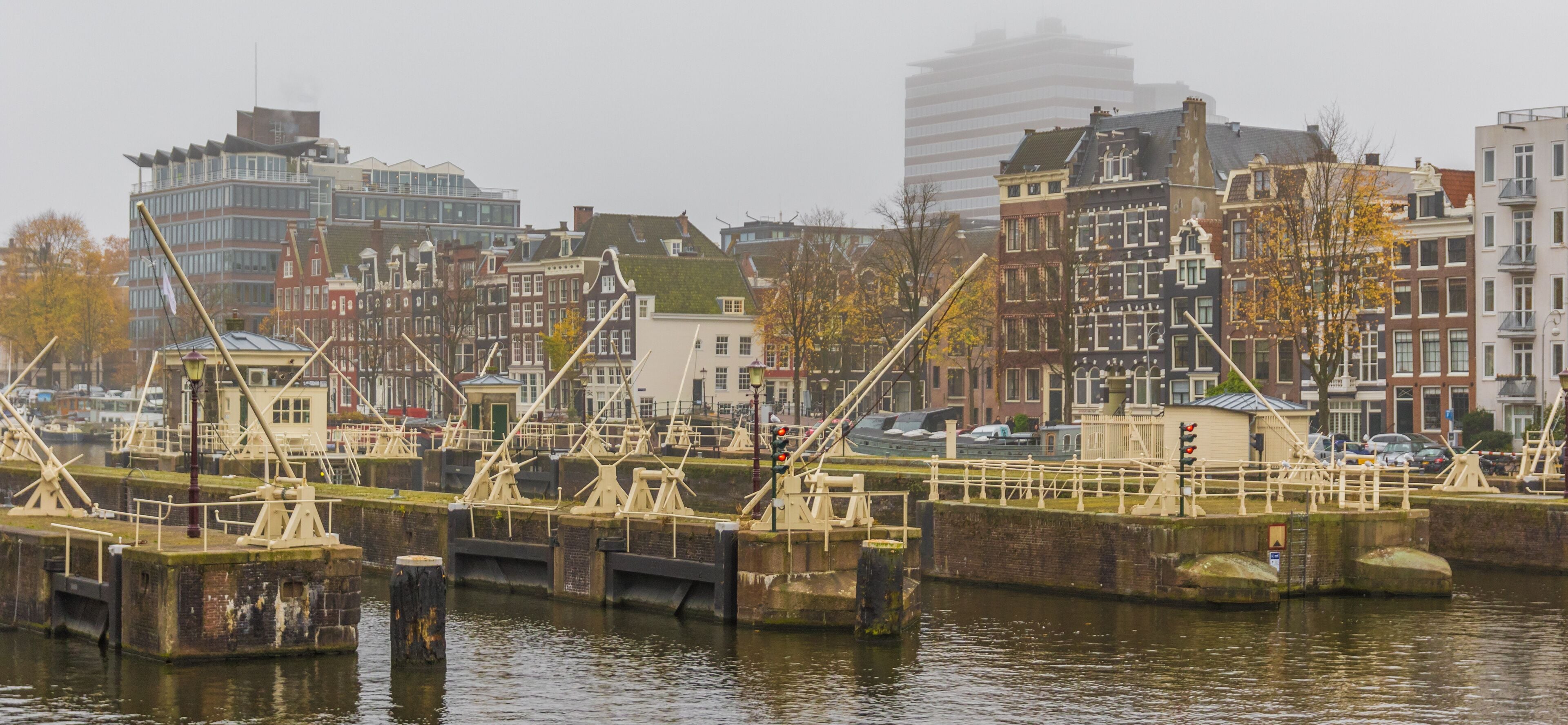 A canal with boats, a bridge, and historic buildings along the water.