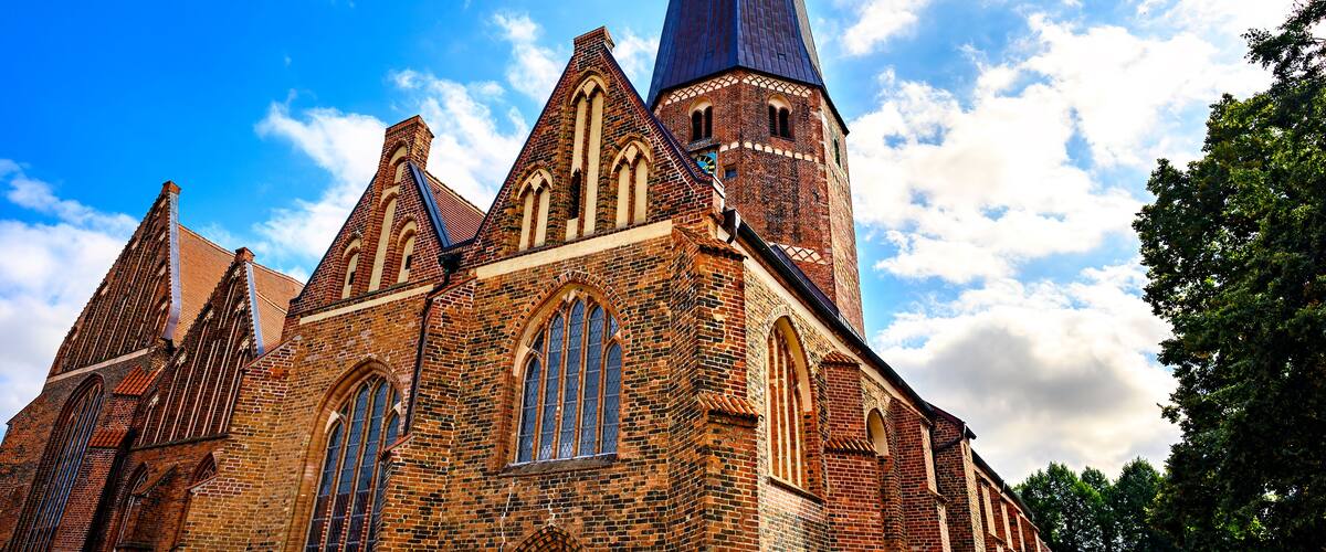 A historic church with a tall spire and multiple pointed arches.