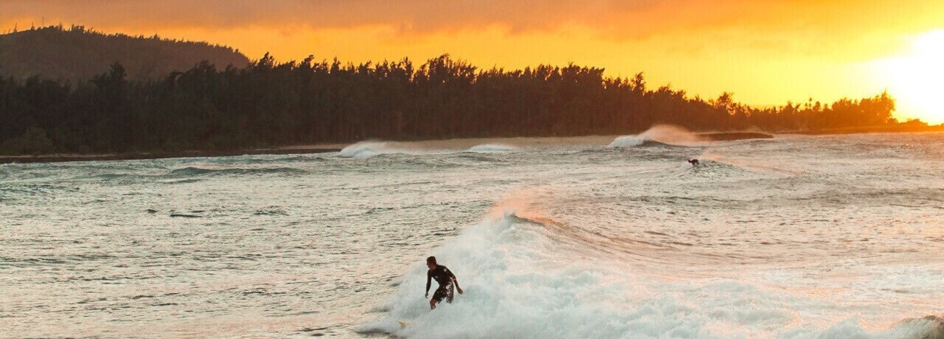 Surfing culture in Hawaii is actually as big a deal as the stereotype portrays! There are people everywhere with surfboards. Sticking out that back of their car, outside their home, or being held as they ride their bikes. I have a lot of respect for that maneuver. Seems like it would take a lot of practice 🏄
