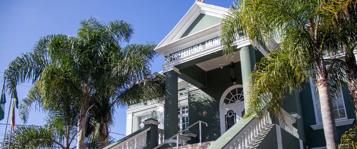 A grand staircase leading to a building with a green facade and white trim.