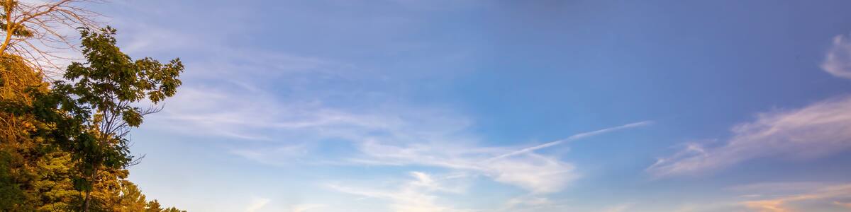 A stunning sunset over a serene beach in Tiny, Ontario, capturing the tranquil beauty and vibrant colors of the evening sky reflecting on the calm waters.