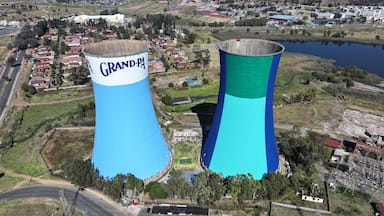 Two large water towers, one labeled 'Grand-Pa' and the other 'Grand-Pa', in a semi-urban area with roads, buildings, and a body of water.