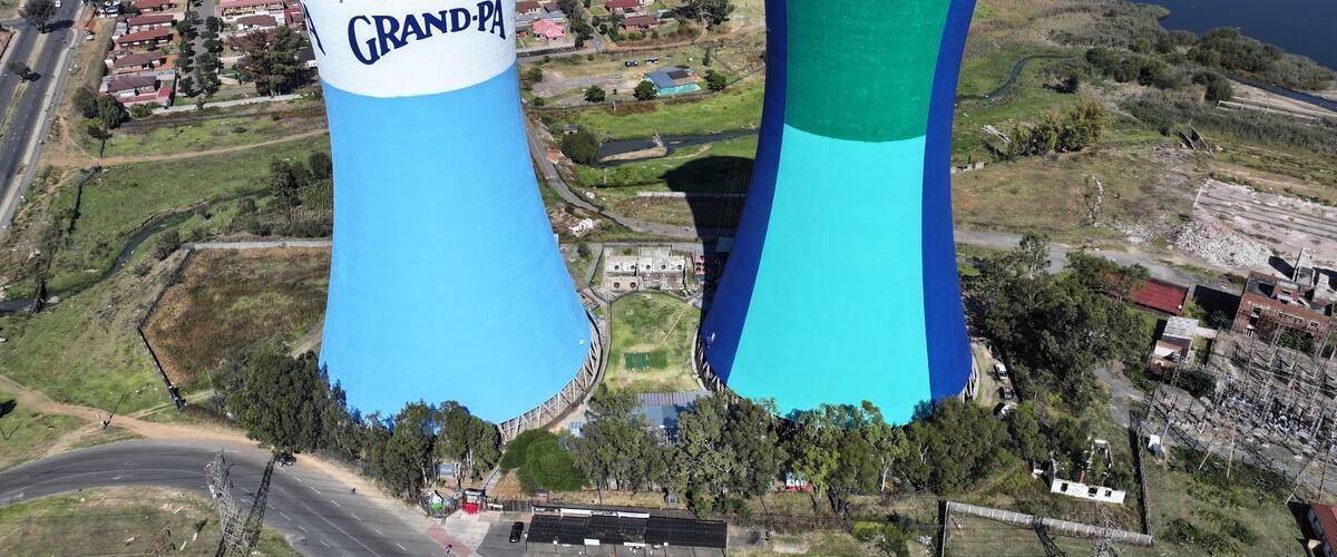 Two large water towers, one labeled 'Grand-Pa' and the other 'Grand-Pa', in a semi-urban area with roads, buildings, and a body of water.