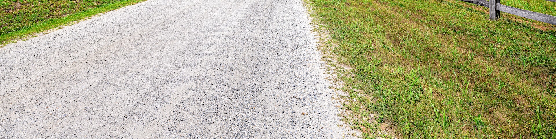 Farm road fence in Roseland, Virginia near Blue Ridge parkway mountains in summer with idyllic rural landscape countryside in Nelson County