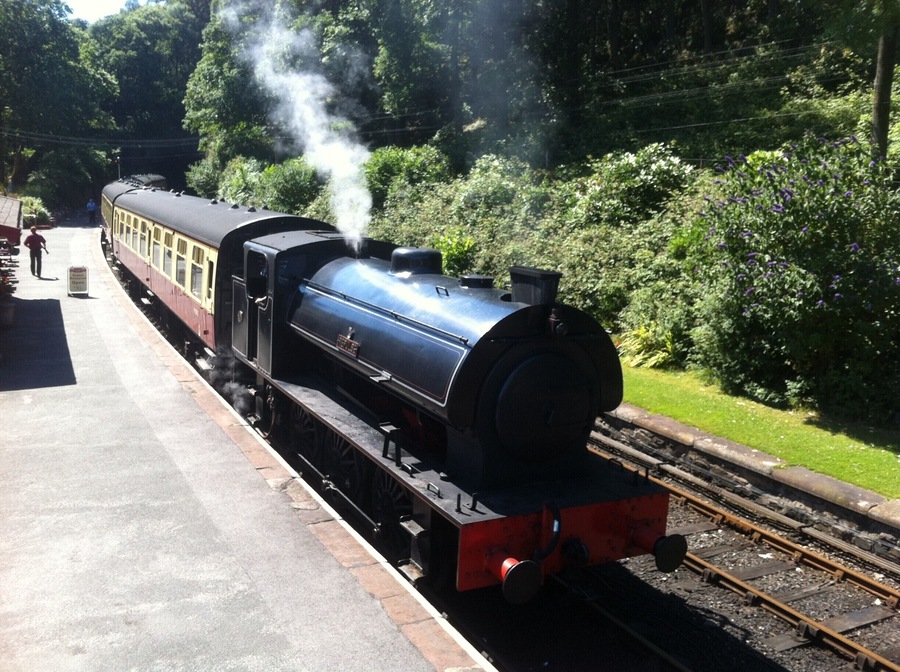 Steam train departing station