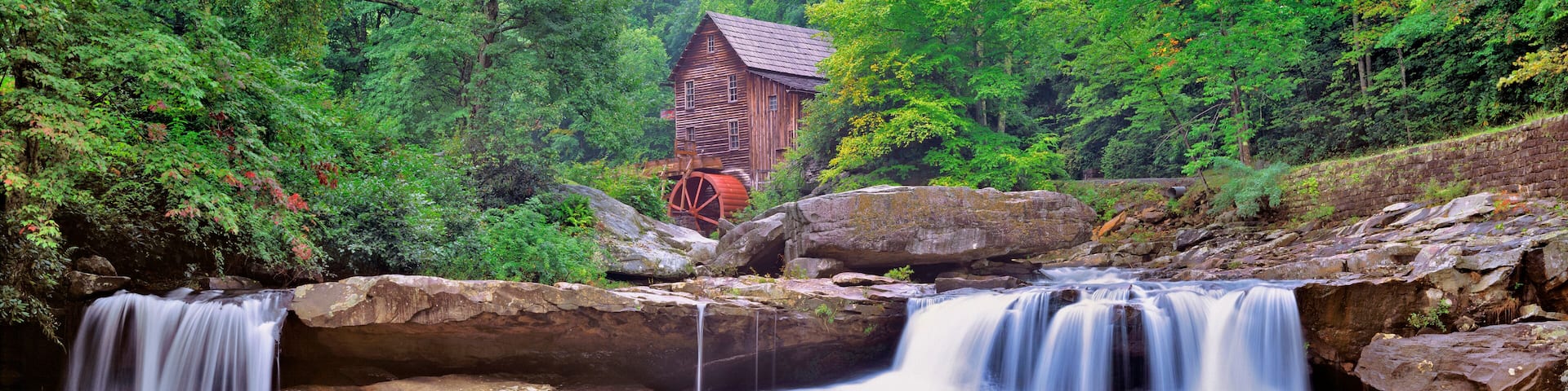 USA, West Virginia, Babcock SP. Two waterfalls form the foreground for Glade Creek Grist Mill, in Babcock State Park, West Virginia.