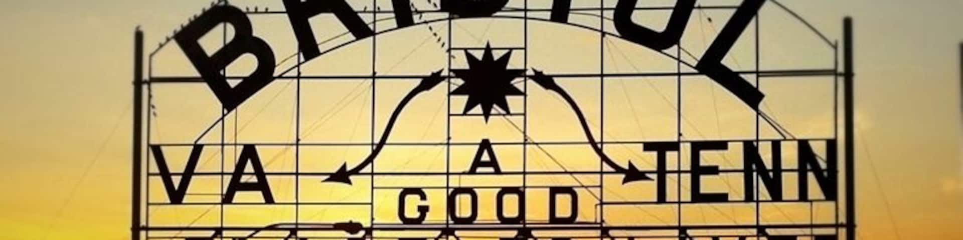 When the Bristol Gas and Electric Company was purchased in 1910 the new owners donated this advertising sign. The “Mammoth Electric Sign”, measuring 60’ wide by 35’ high, was shipped by rail and dedicated on July 4 to a crowd of over 3,000 citizens. For its first five years it was perched on the top of The Interstate Hardware building until it was removed in 1915 to its present location over State Street. The original slogan read, “Push, That’s Bristol”, which was the mantra for the era’s industrial “push” that centered in Bristol. In 1921 the polish of the sign had diminished Bristol’s marketing icon when its lights would flicker “PU” That’s Bristol or “SH” that’s Bristol, and a citywide campaign chose its current slogan. In 1988 it was accepted to the National Register of Historical Places.
In 2010 this enormous structure, the Bristol Slogan Sign, marked its 100th year on the eastern end of downtown Bristol, itself straddling State Street. It has been a part of community pride and the one structure in the city that has identified Bristol’s common purpose and heritage. The message on this sign has been the marketing slogan for the city for close to 90 of those years, and considered one of the oldest community slogans in the United States. It reads, “Bristol Va – Tenn, A Good Place To Live”.