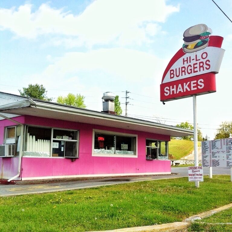A pink building with a sign for Hi-Lo Burgers and shakes.