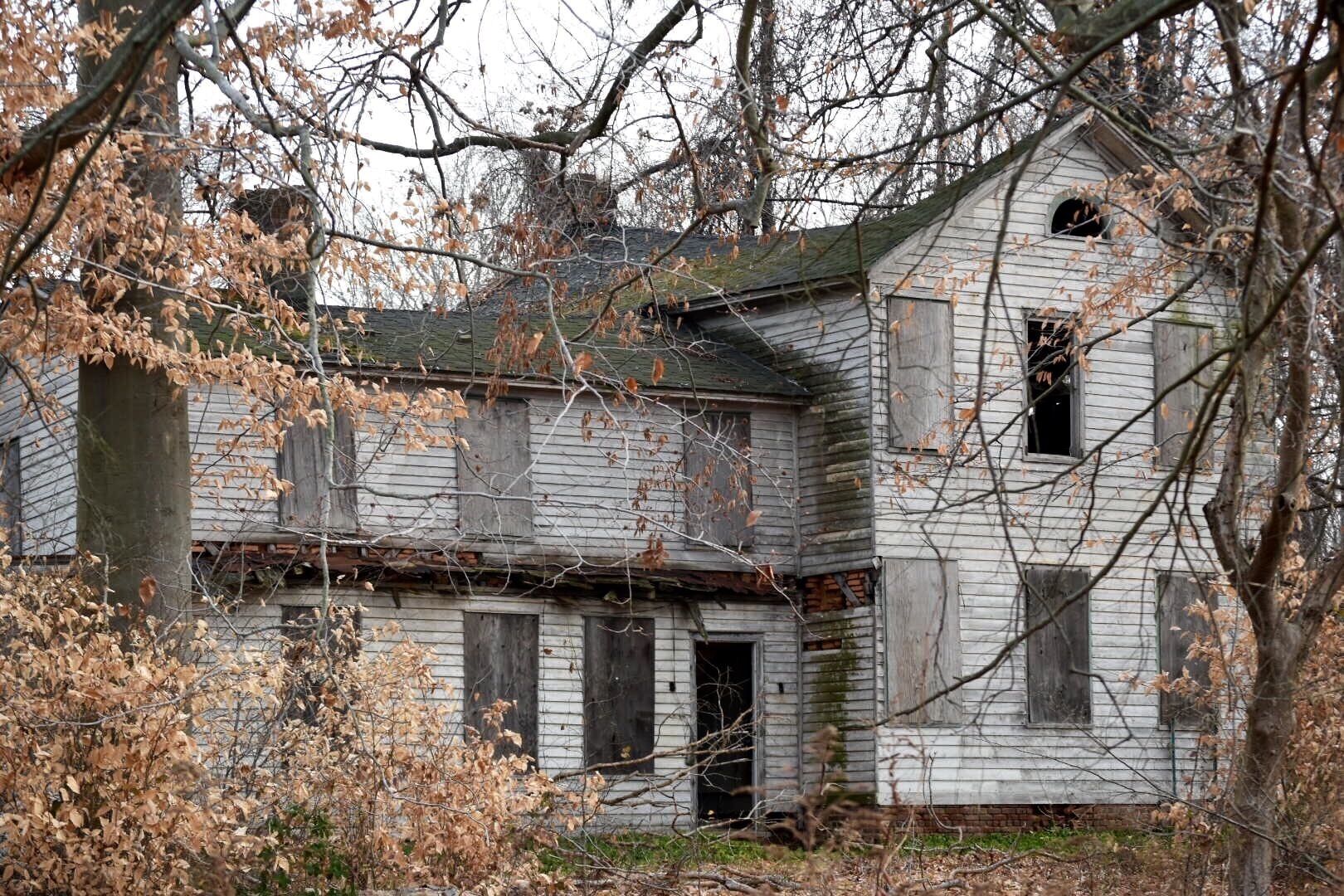 Off the beaten track. 
The Thompson-Taylor farmhouse. It's falling in on itself slowly. Floors & ceiling collapsing into the basement. Use extreme caution if hiking here. Open basements, & old covered up wells. Stick to the path if not familiar with the site.