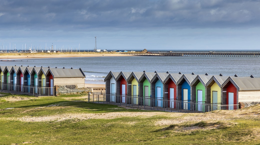 Line of colourful British beach huts at Blythe, Northumberland on the Northumbria Coast.