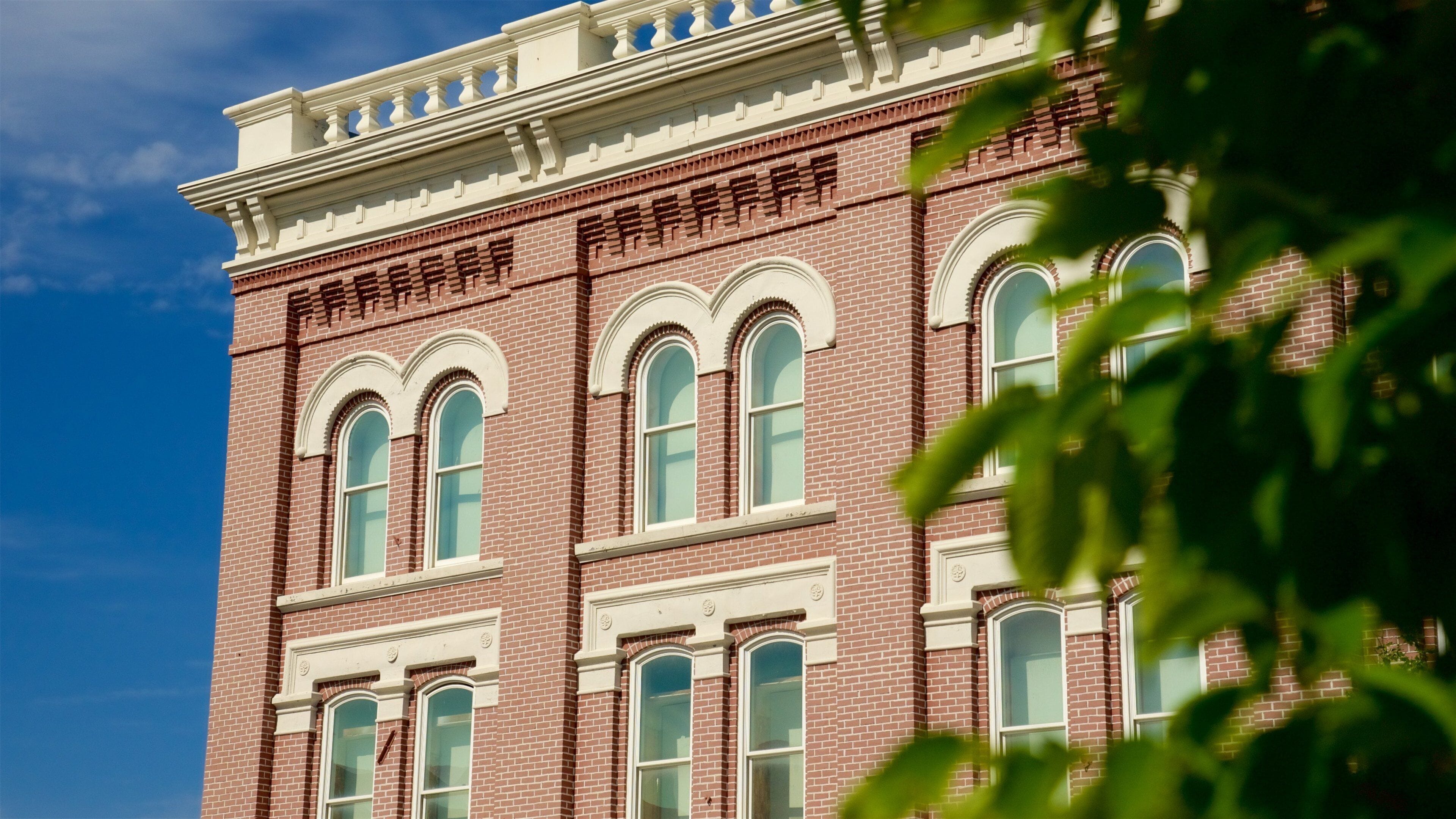 A red brick building with white trim and arched windows.