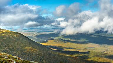 The slopes of Mt Adams viewed from Mount Washington road, on a sunny fall afternoon, in New Hampshire. A thick layers of clouds covers the valley above the city of Berlin, NH