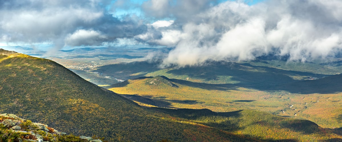 The slopes of Mt Adams viewed from Mount Washington road, on a sunny fall afternoon, in New Hampshire. A thick layers of clouds covers the valley above the city of Berlin, NH