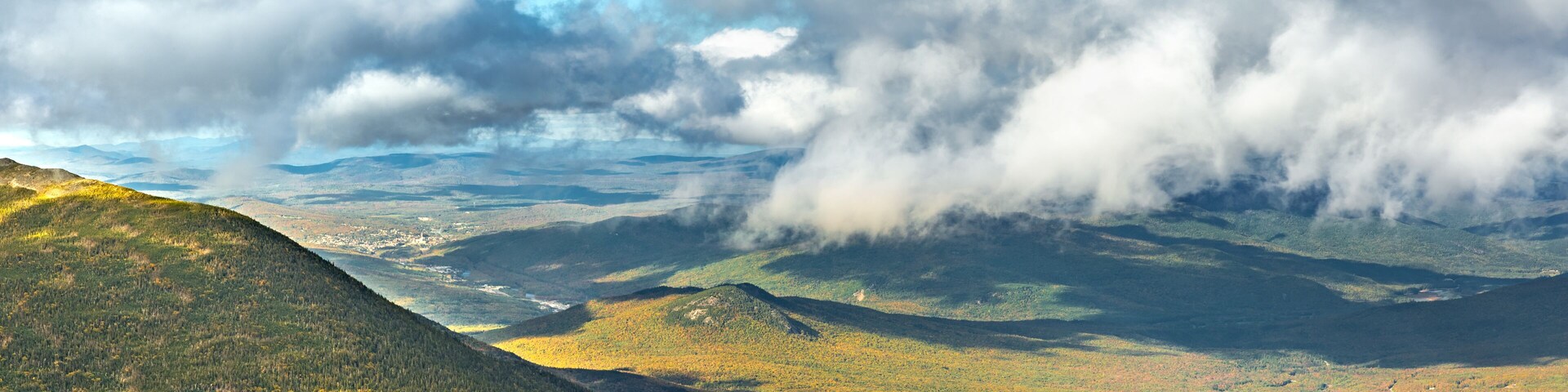 The slopes of Mt Adams viewed from Mount Washington road, on a sunny fall afternoon, in New Hampshire. A thick layers of clouds covers the valley above the city of Berlin, NH