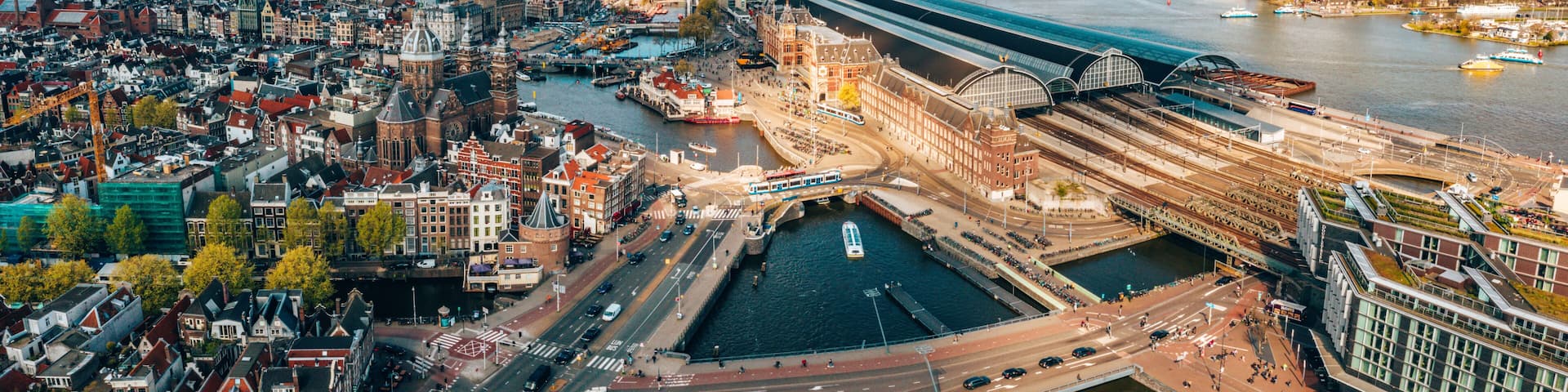 Beautiful aerial Amsterdam view from above with many narrow canals, streets and architectures.