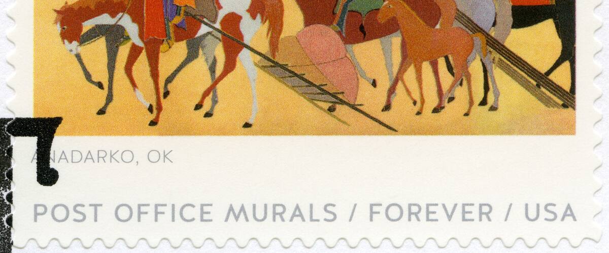 A postage stamp with a Native American scene, horses, and people.