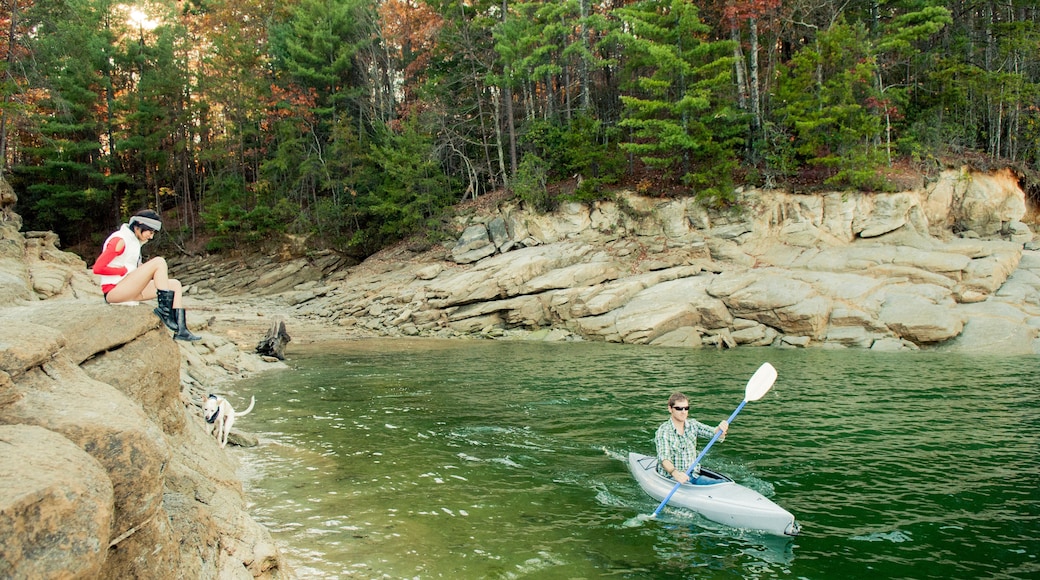 Woman watching boyfriend in kayak in lake