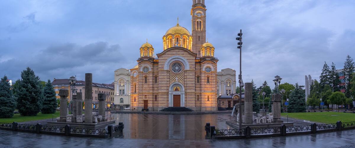 A historic church with multiple domes and a tall bell tower.
