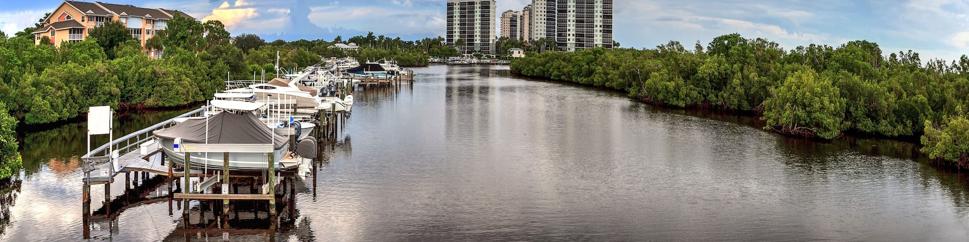 Boats docked in a harbor along the Cocohatchee River in Bonita Springs