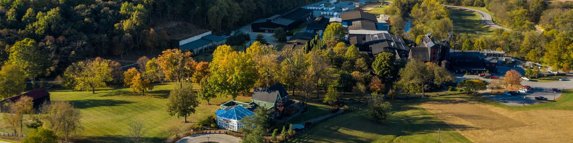 An aerial view of a campus with buildings, roads, and surrounding greenery.