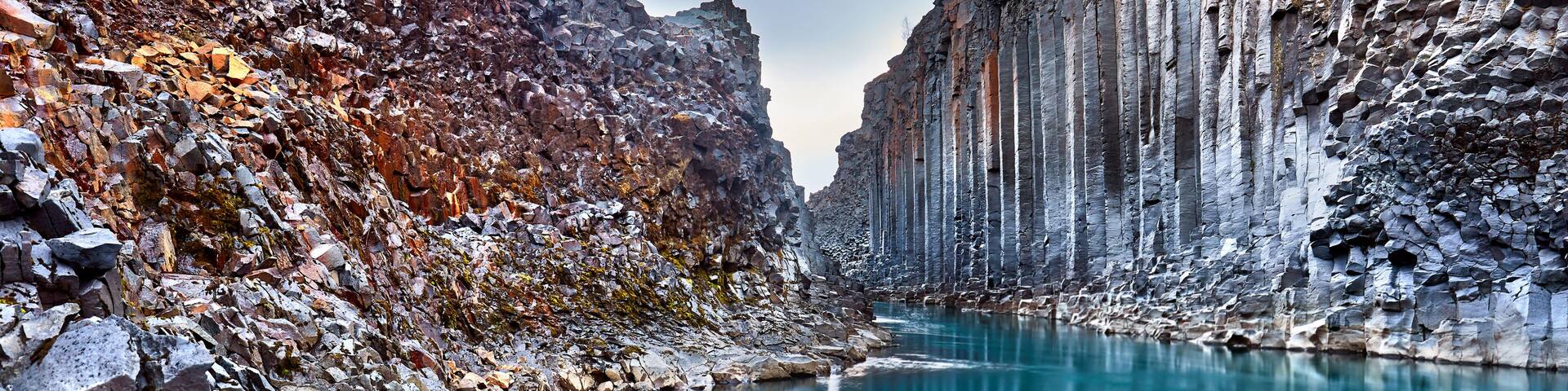Studlagil basalt canyon, Jokulsa a Dal River. Iceland, Europe. One of the most wonderfull hidden place and nature sightseeing. Famous tourist landscape with basalt rock formations. Travel postcard.