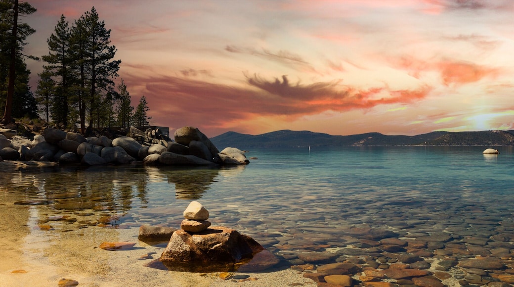 Panoramic mountain landscape scene in Lake Tahoe California with a colorful sunset in the background