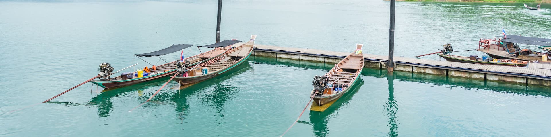 Boats are docked at the marina in Ratchaprapha dam, Surat Thani,