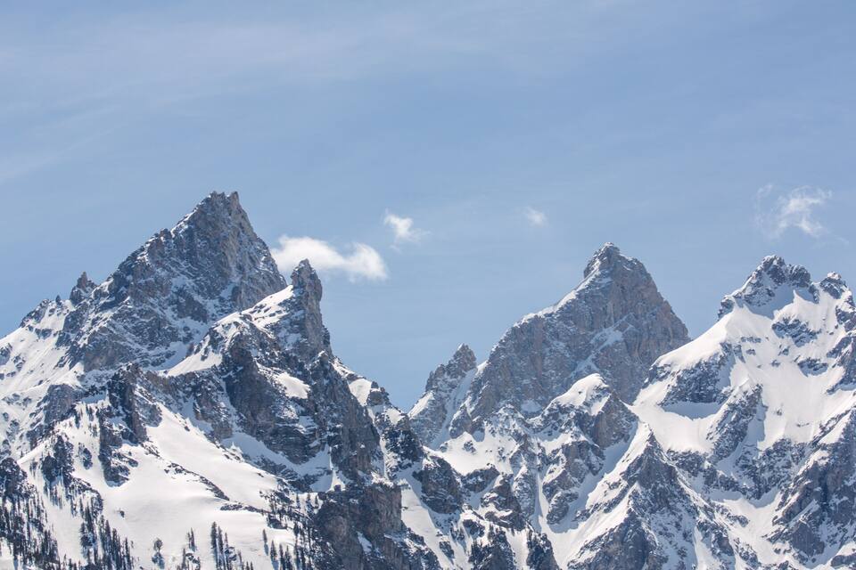 Snow-covered mountain peaks under a clear sky.