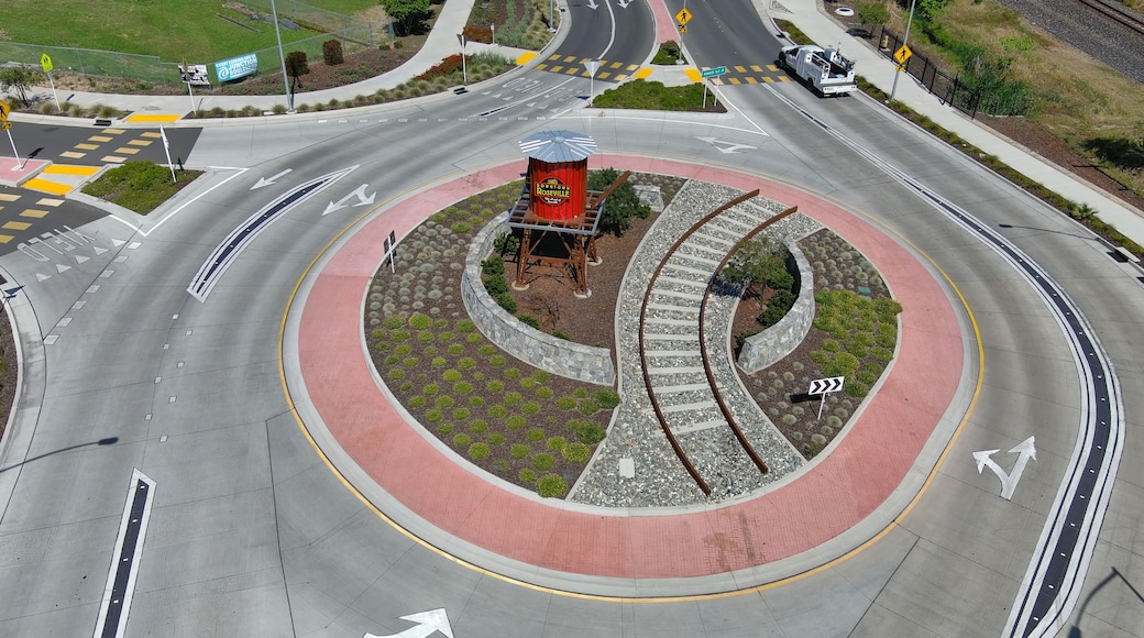 A roundabout with a central monument, multiple lanes, and surrounding landscaping.