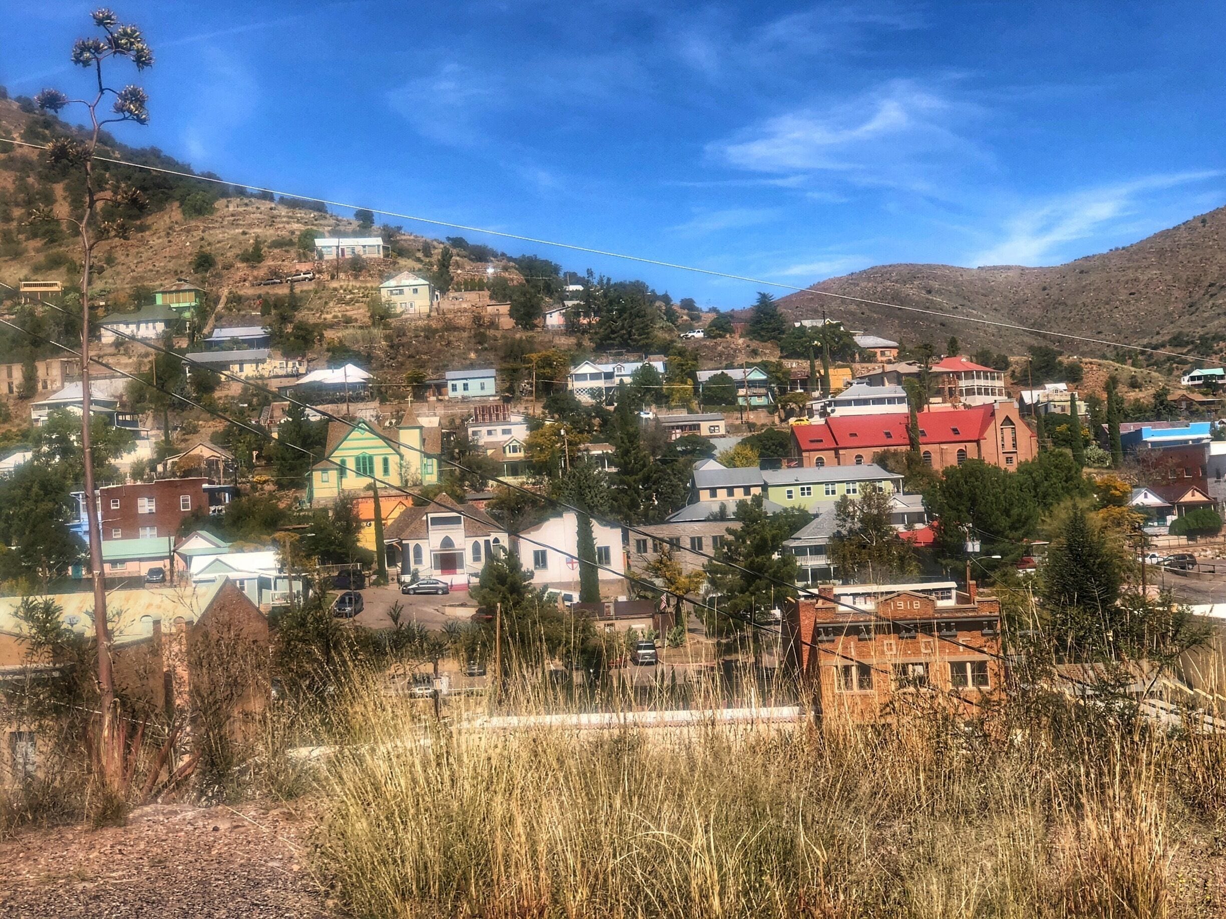 A hillside town with colorful houses and a prominent red-roofed church.