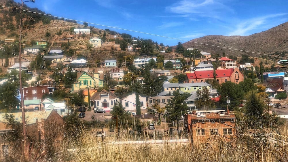 A hillside town with colorful houses and a prominent red-roofed church.