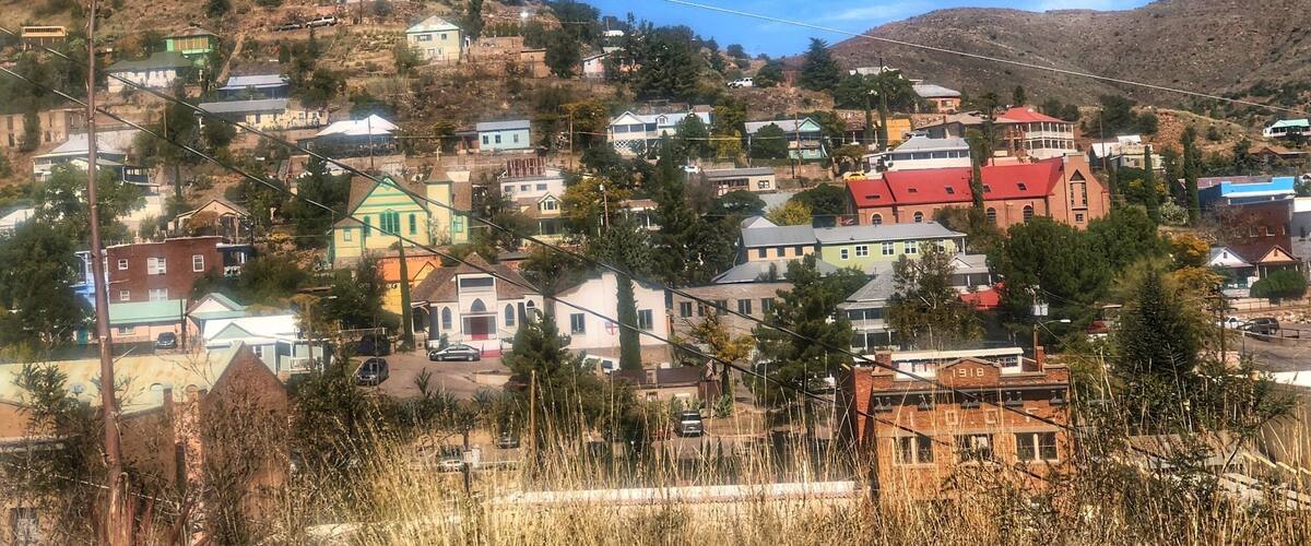 A hillside town with colorful houses and a prominent red-roofed church.