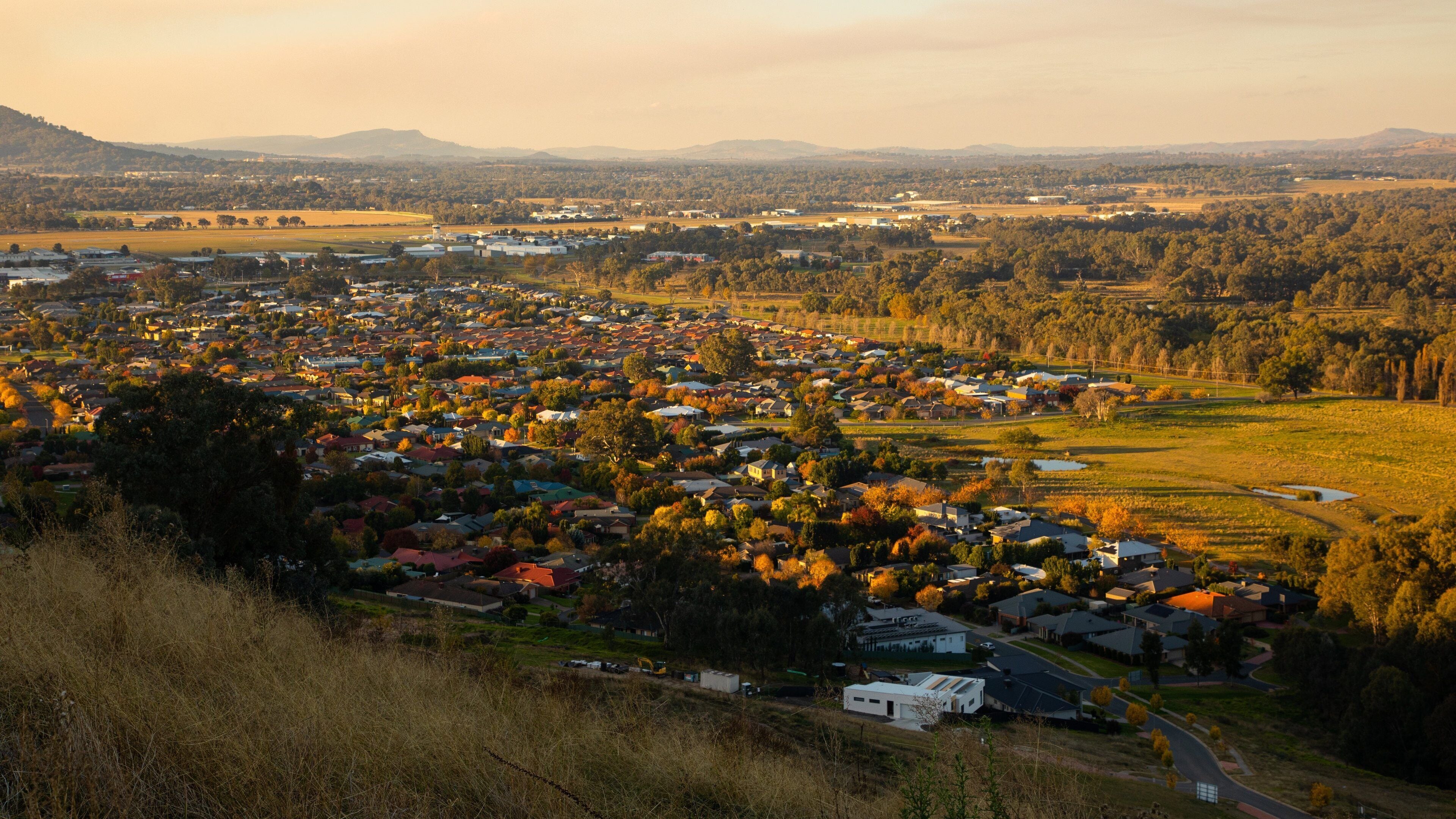 Albury showing a small town or village, landscape views and a sunset