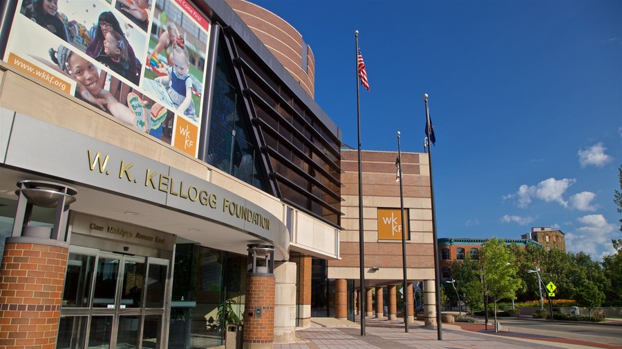 The W.K. Kellogg Foundation building with a large billboard and American flags.