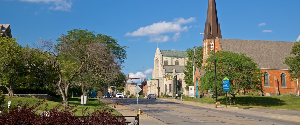 A street with a church and a tall steeple.