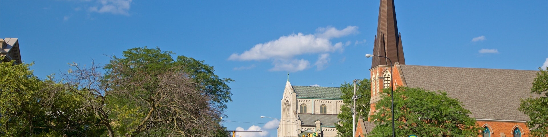A street with a church and a tall steeple.
