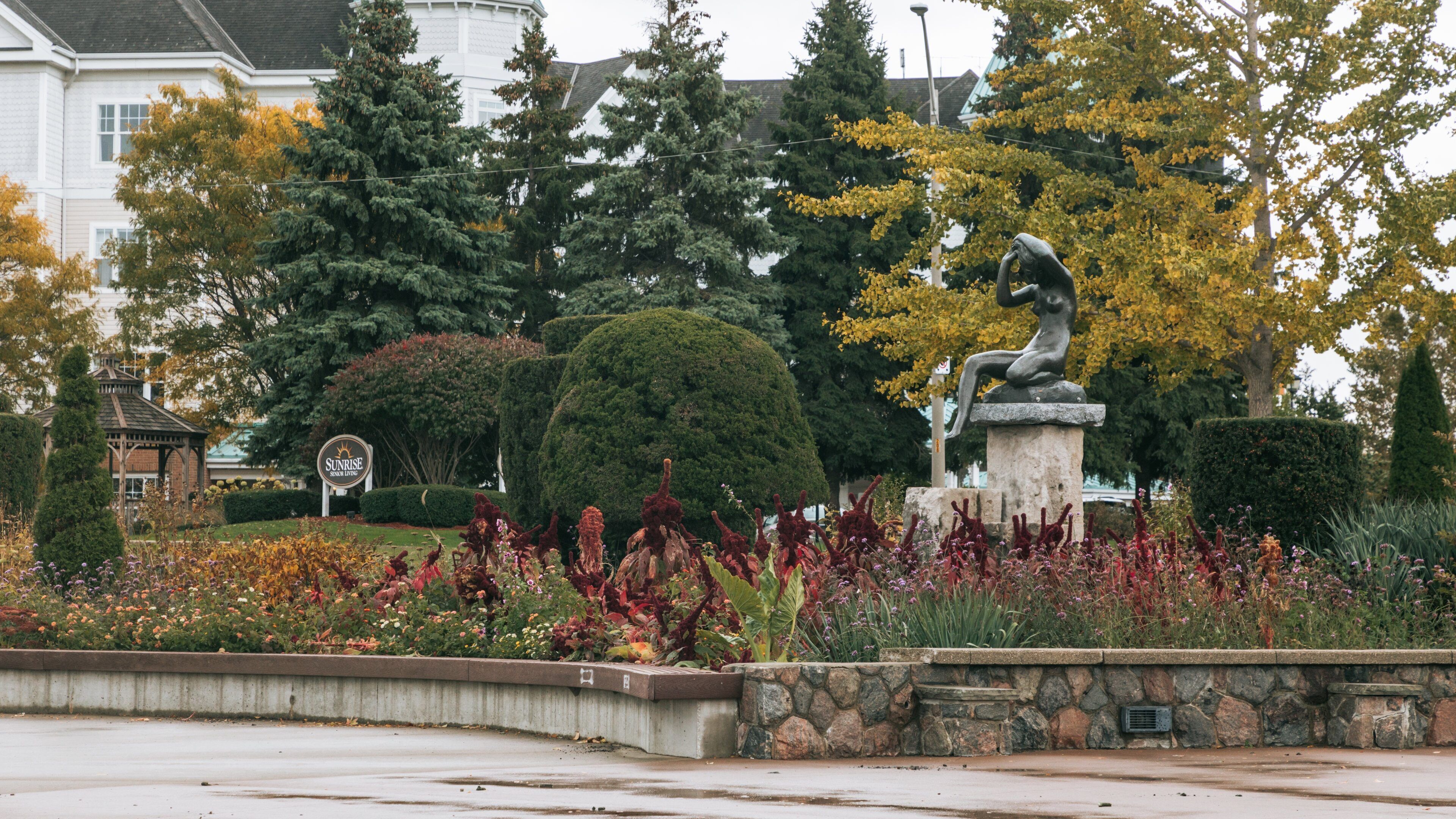 Reaume Park and Coventry Gardens Walking Trails Trailhead which includes a statue or sculpture, a garden and wildflowers