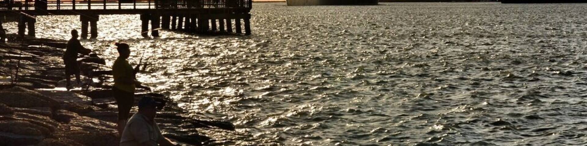 A view of Aransas Pass from the Port Aransas side. At sunset, go get a pizza and watch the ships pass through and dolphins swim nearby. So much to see, and a very relaxing spot. Stay until after dark so that you can hear the dolphins pop up for air in the nearby waters. It's also a great fishing spot.