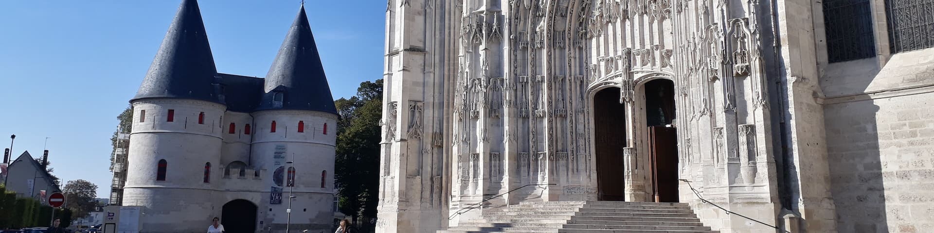A historic cathedral with intricate Gothic architecture, including pointed arches and detailed stone carvings.