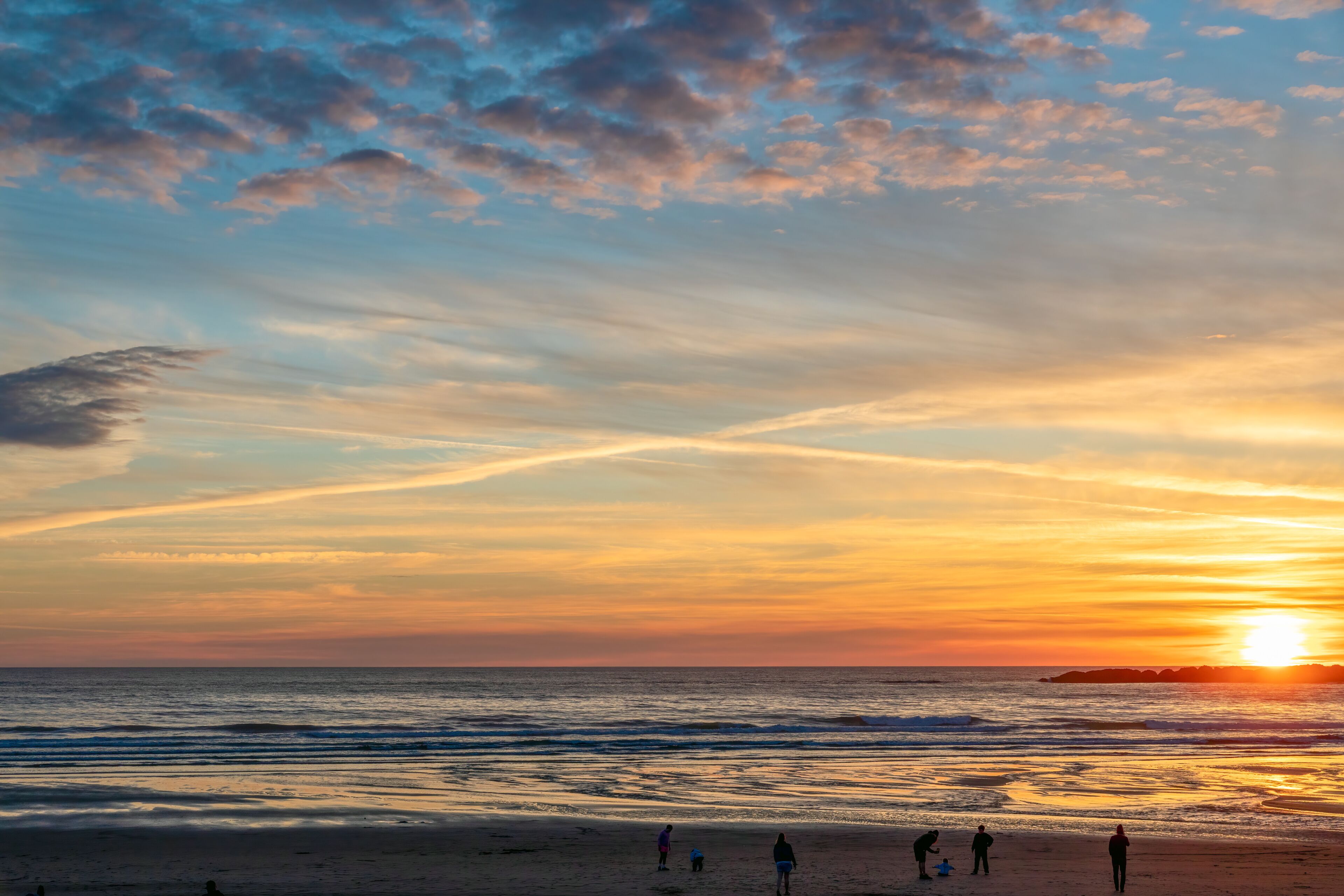 Sunset at Beverly Beach with family playing on the shore