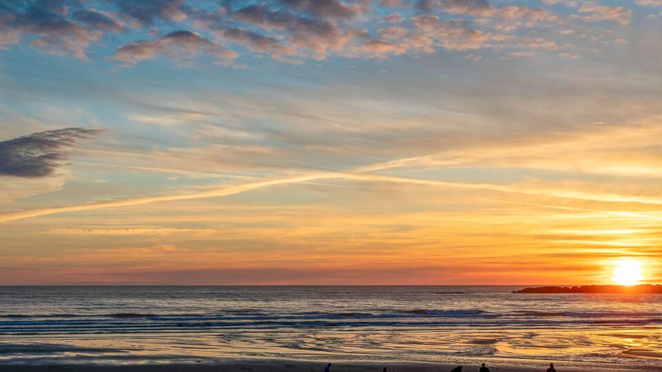 Sunset at Beverly Beach with family playing on the shore