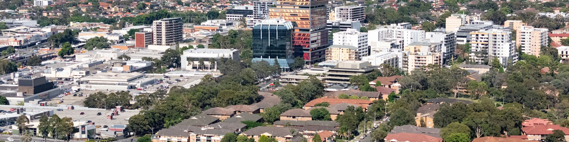 Low aerial drone view of the east side of Bankstown cbd in Sydney NSW, Australia looking from above Greenacre in November 2024