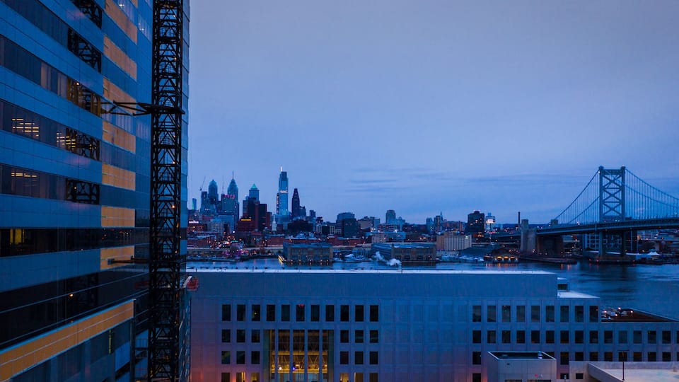 A city skyline with a prominent bridge and skyscrapers.